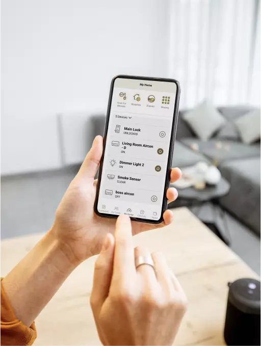 Woman using the Habitap app to control IoT devices in her living room