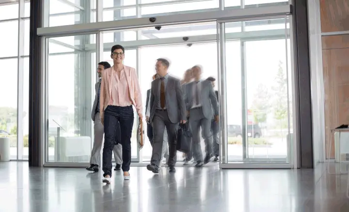 A group of professionals entering a commercial building and a busy office with constant people movement will benefit from smart access management